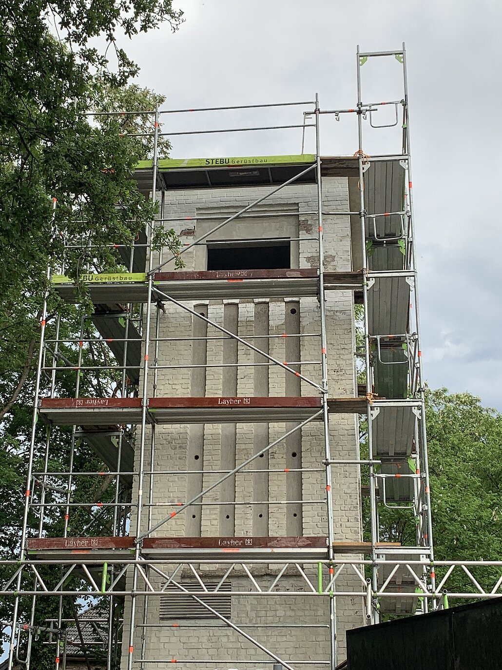 Der Trafoturm ist während des Ausbaus in ein Baugerüst gefasst.