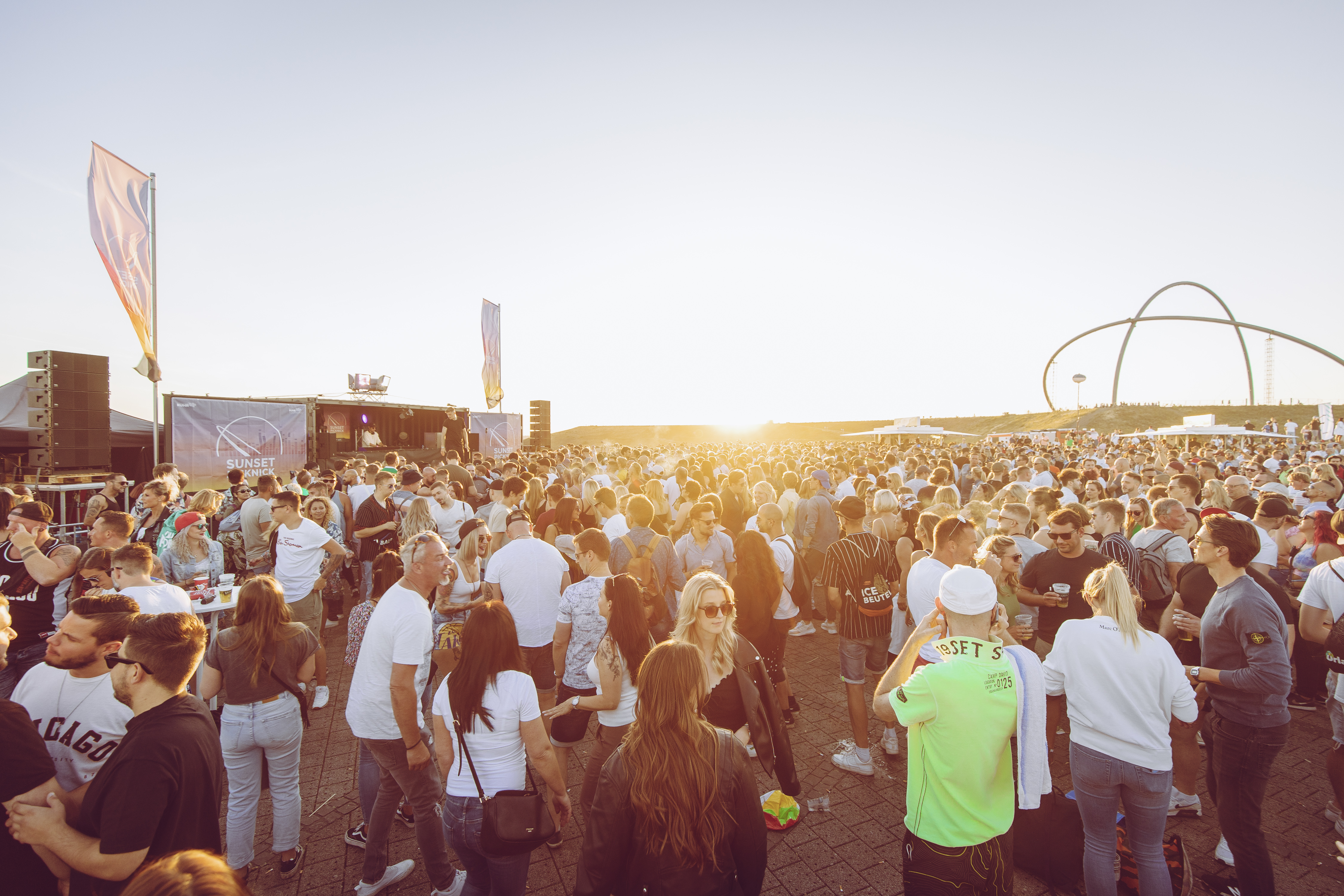 Menschen tanzen auf der Halde Hoheward in der Abendsonne.